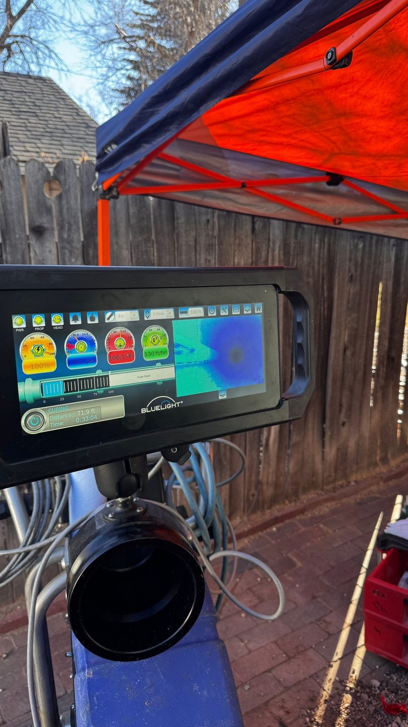 Monitor on an Affordable Rooter job site showing a live camera view inside a sewer pipe